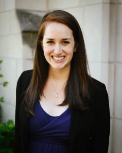 Headshot photograph of Jessica Moerman. She is the executive director of the Evangelical Environmental Network (EEN). She is a white woman with long brown hair and wearing a purple shirt and black suit jacket. She is smiling.