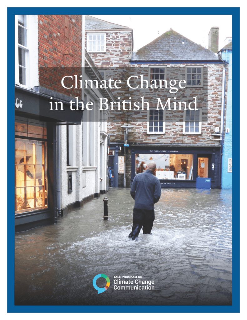 Cover the Climate Change in the British Mind report. Man wades through flooded Cornish high street in the village of Fowey.