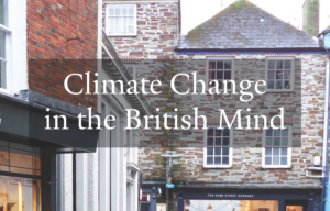 Cover for the Climate Change in the British Mind report. A man wades through a flooded Cornish high street in the village of Fowey, England.